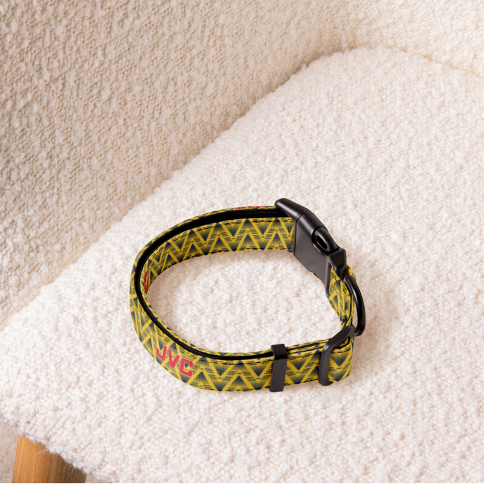 Yellow football dog collar sitting on a cream armchair