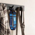 Blue football dog collar hanging on a wall hook with a shirt and leash