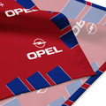 A close-up of a red Opel-branded textile or flag with blue and light pink geometric blocks and repeated white Opel logos, shown folded on a white background.