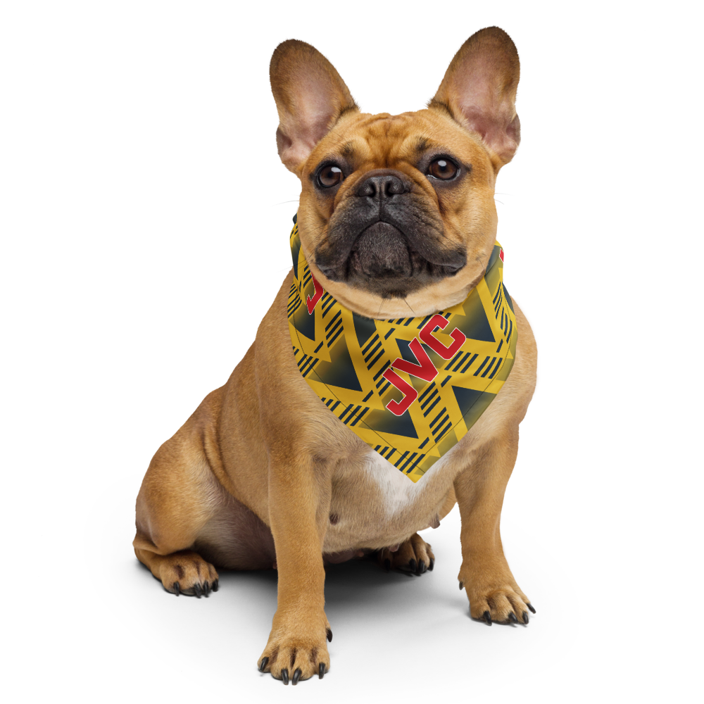 A fawn French Bulldog wearing a yellow and black caution-tape patterned bandana with red 'JVC' lettering, set against a plain white background.