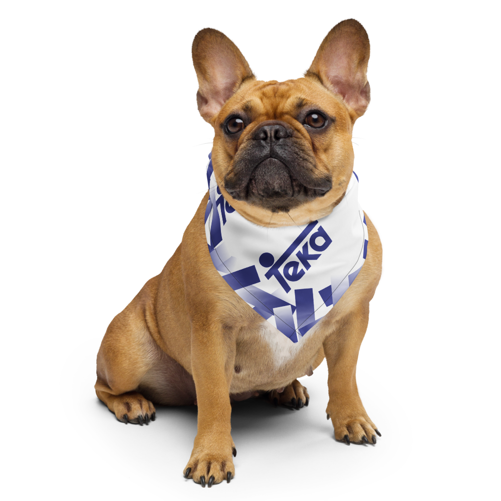 A fawn French Bulldog wearing a white bandana with blue geometric patterns and the brand name 'Teka' printed on it, set against a solid white background.