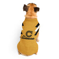 A small tan dog viewed from behind wearing a mustard yellow pet shirt with black and white graphic stripes and a black 'Die Continental' logo on the back, against a plain white background.
