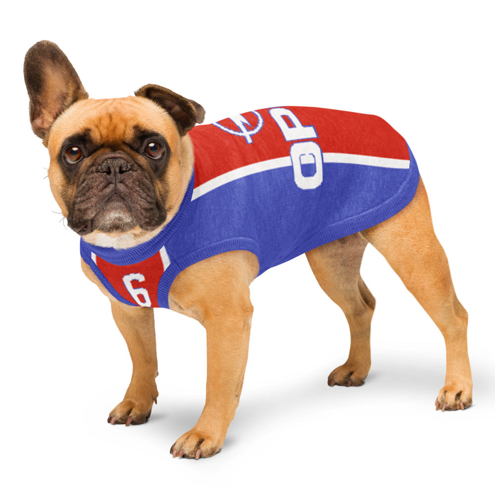 A fawn French bulldog wearing a red, blue, and white dog jersey with the number 6 and 'OPP' lettering, standing against a white background.