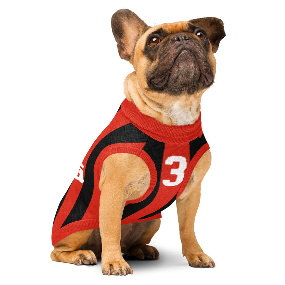 A fawn French bulldog wearing a red and black athletic dog sweater with the number 3 on the back, photographed against a solid white background.